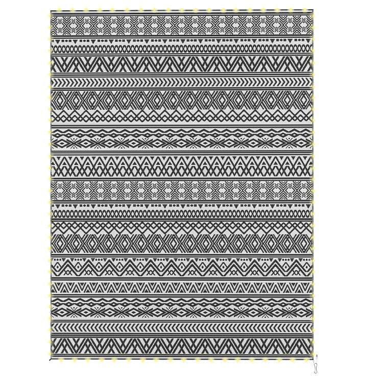Reversible patio rug with black-and-white geometric stripes and fringe edges