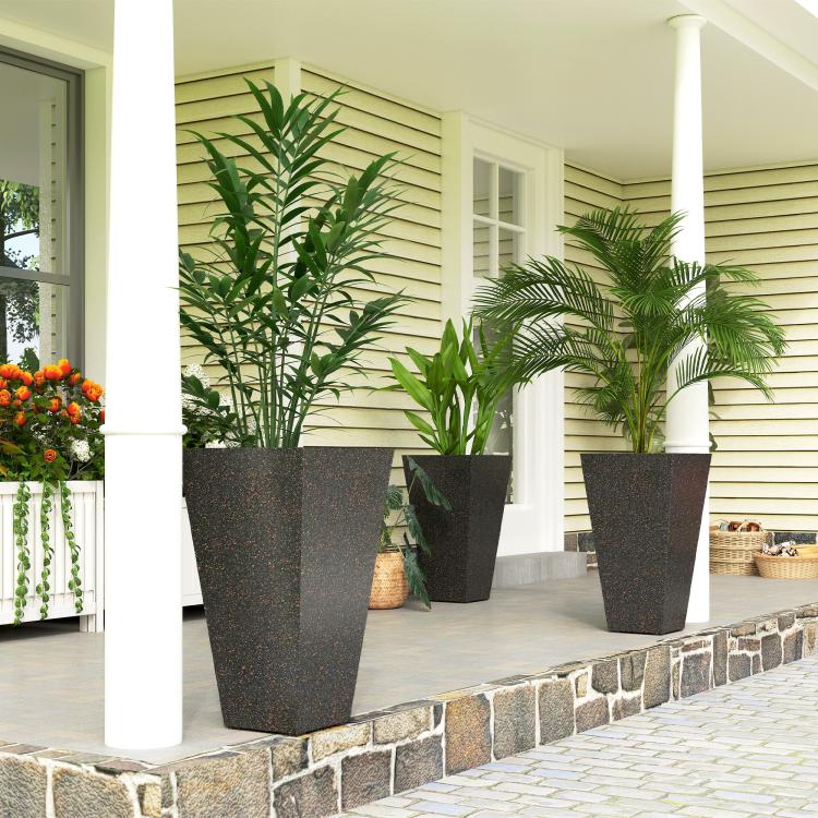 Tall outdoor planters set of 3 with dark speckled finish, holding green potted plants
