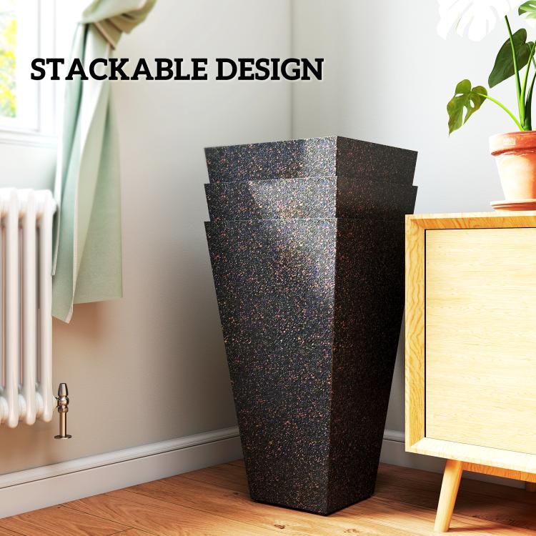 Stackable tall tapered planters, three dark speckled pots stacked indoors