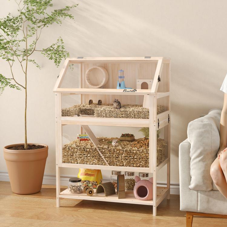 Wooden multi-level hamster cage with hut, ramp, and visible bedding floor
