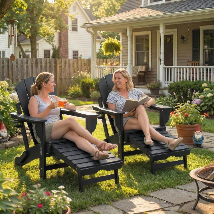 Two black folding adirondack chairs with retractable ottomans and cup holders