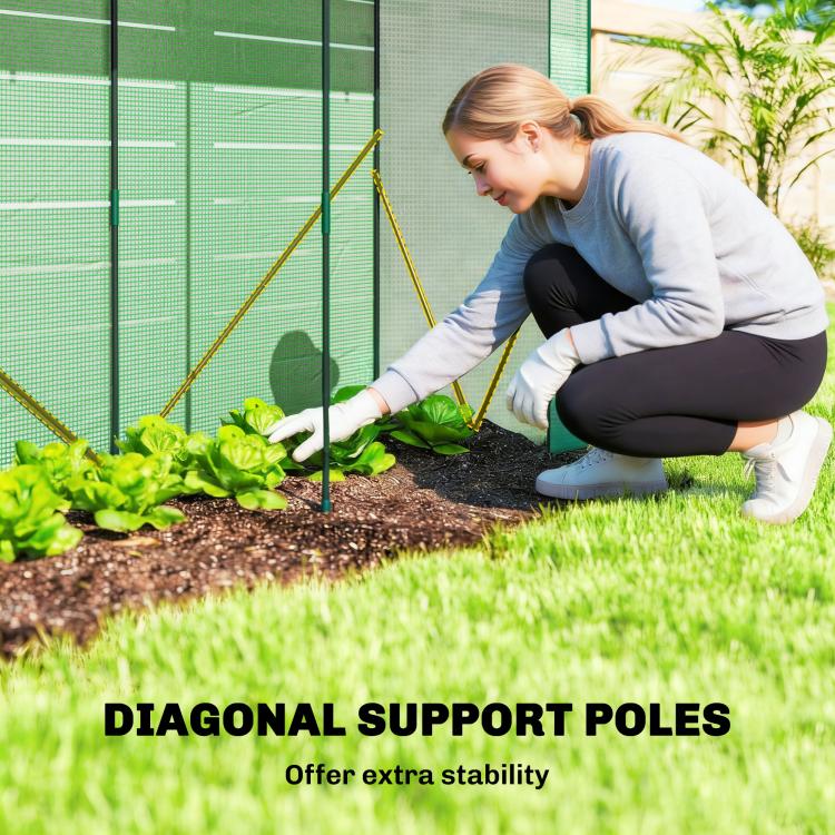 Person kneeling to plant in a green mini greenhouse with diagonal support poles