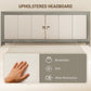 Upholstered gray bed headboard with vertical channel padding