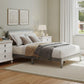 Gray full platform bed with upholstered headboard and neutral bedding