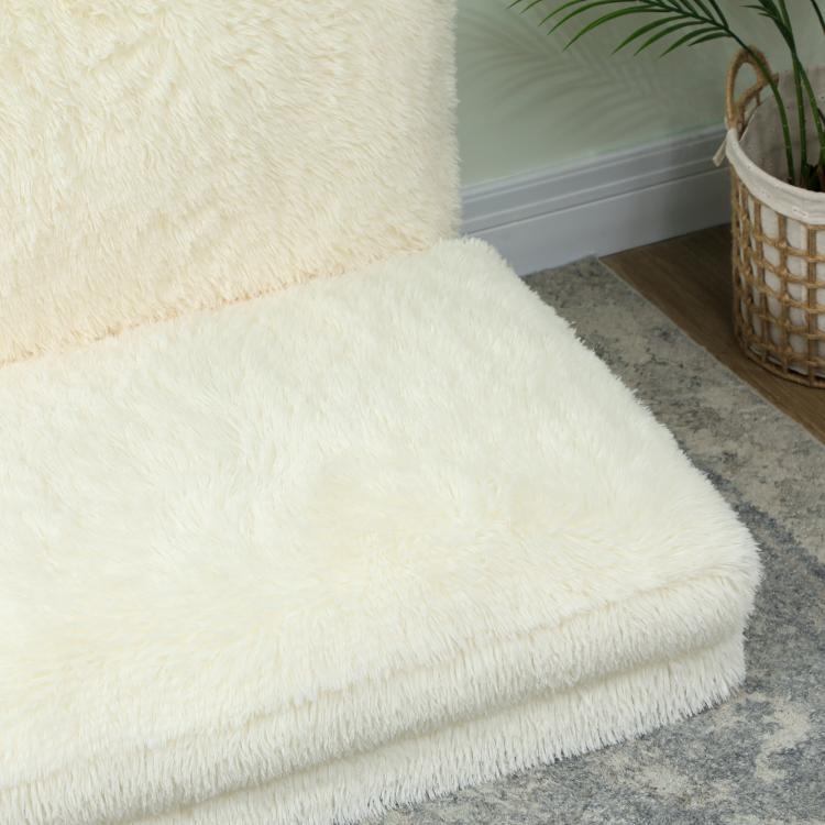 Cream plush folding floor mattress sofa, close-up of thick edge and smooth pile