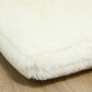 Cream white plush shag fabric on the edge of the floor sofa bed mattress