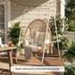White A-frame steel hanging chair stand with hanging egg chair on porch