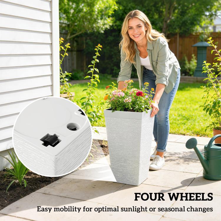 Set of three white wheeled outdoor planters for easy moving