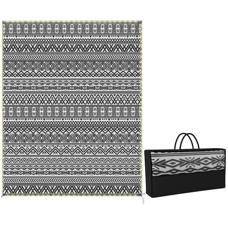 Reversible outdoor rug with black-and-white geometric pattern, with matching carry bag.