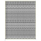 Reversible patio rug with black-and-white geometric stripes and diamond motifs.