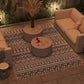 Geometric outdoor area rug with black and white patterned design