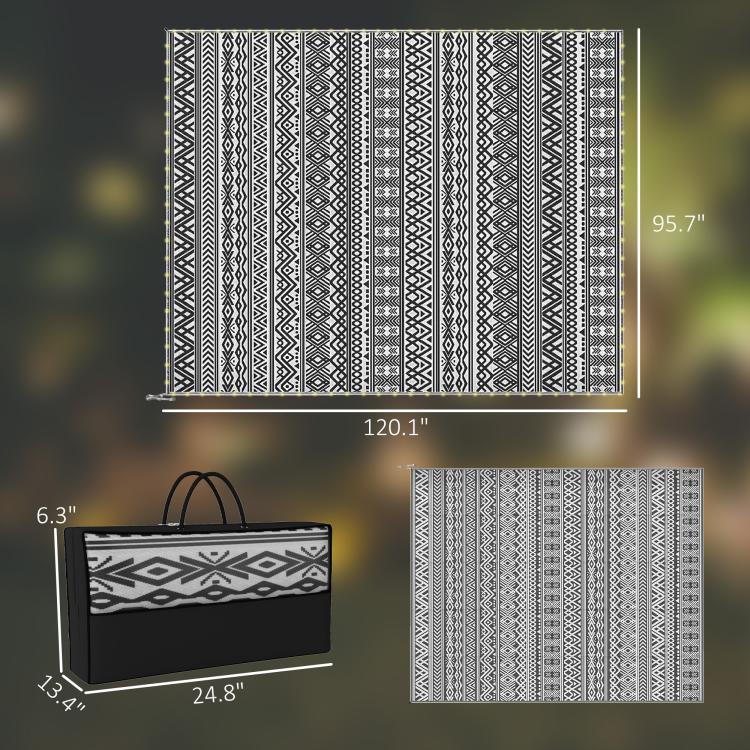 Black-and-white geometric rug, shown with folded carry bag and size diagram.