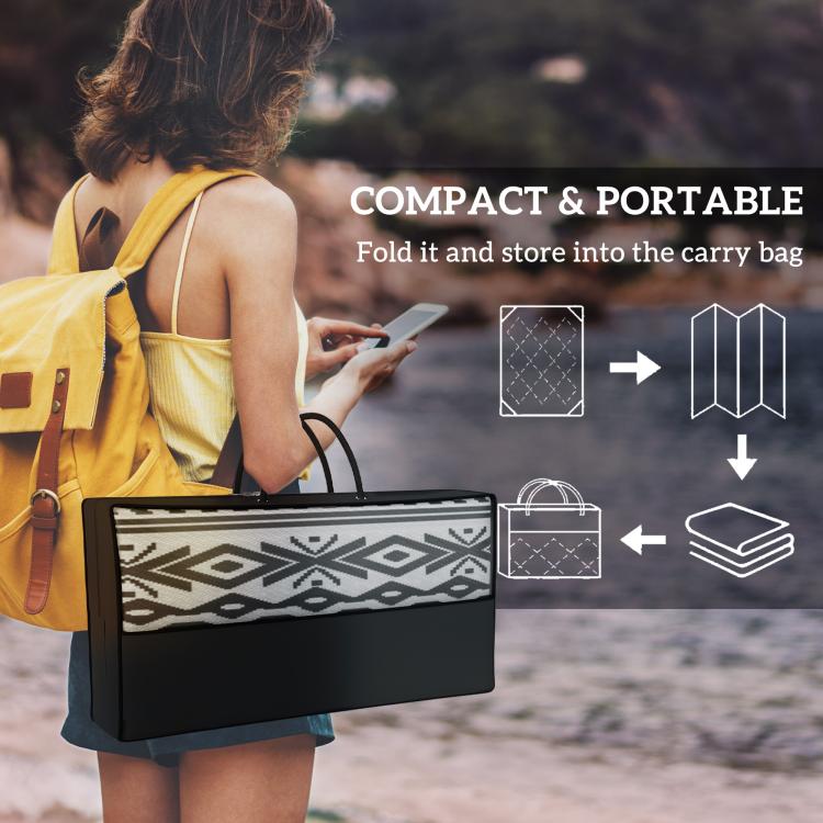 Portable camping rug in black carry case with black-and-white geometric panel.