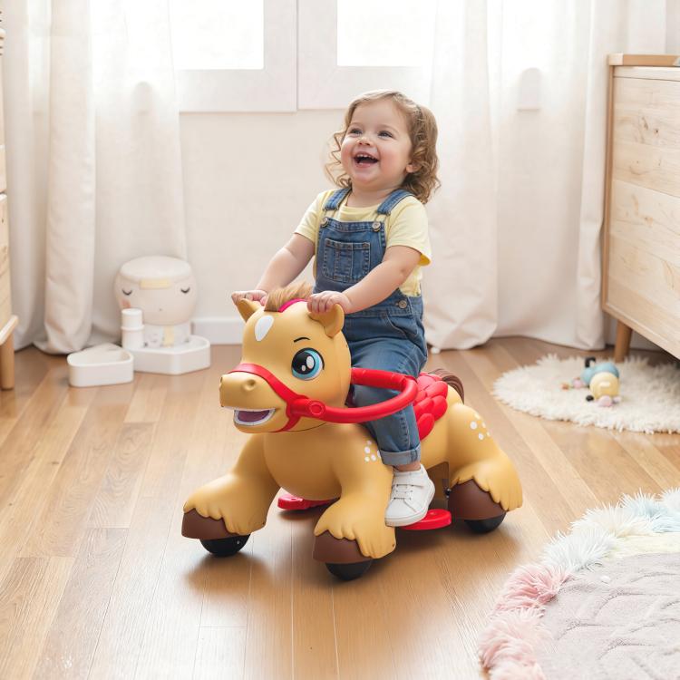 Child riding a tan rocking horse toy with red reins indoors