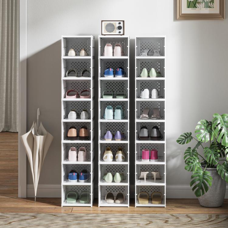 Three white stackable plastic shoe storage towers with clear doors, filled with shoes