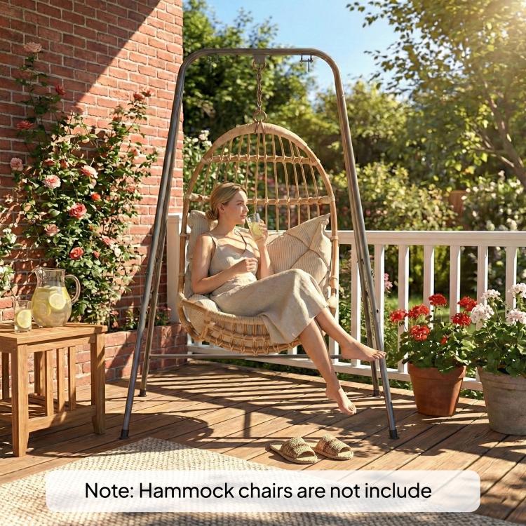 Gray hammock chair stand with hanging hammock chair and cushion outdoors