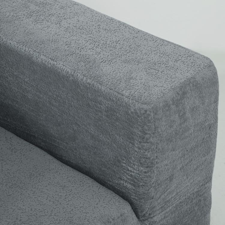 Dark gray textured sofa armrest and seat corner, rounded back cushions