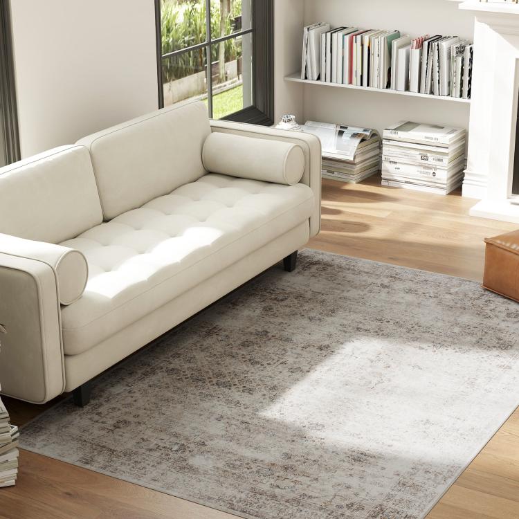 Rectangular distressed area rug in gray and brown tones