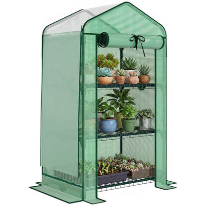 Green mini greenhouse with screened walls, roll-up door, and metal wire shelves inside