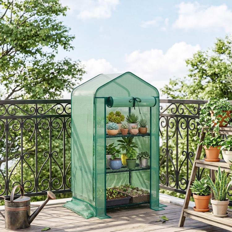 Green portable mini greenhouse with roll-up door, screened walls, and open front access