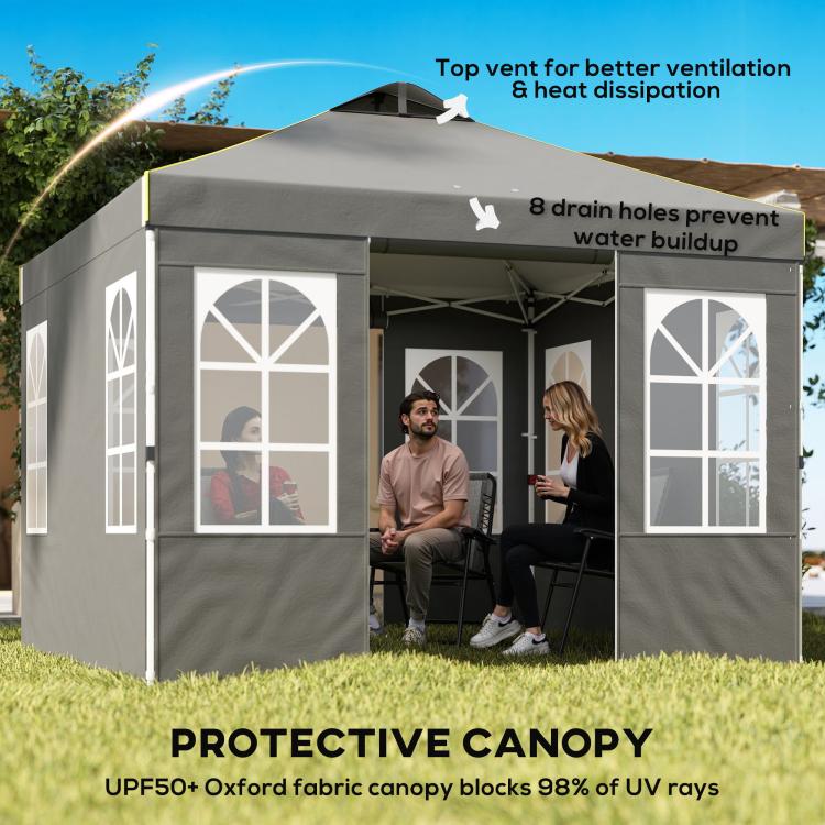 Dark gray pop-up canopy tent with sidewalls and multiple windows, seated outdoor area inside