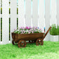 Mobile wooden wagon planter on wheels with flowers, standing on green grass