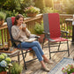 Red padded high-back folding patio chair with armrests and gray metal frame