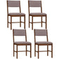 Four dining chairs with gray linen upholstery and brown wooden legs, straight backs