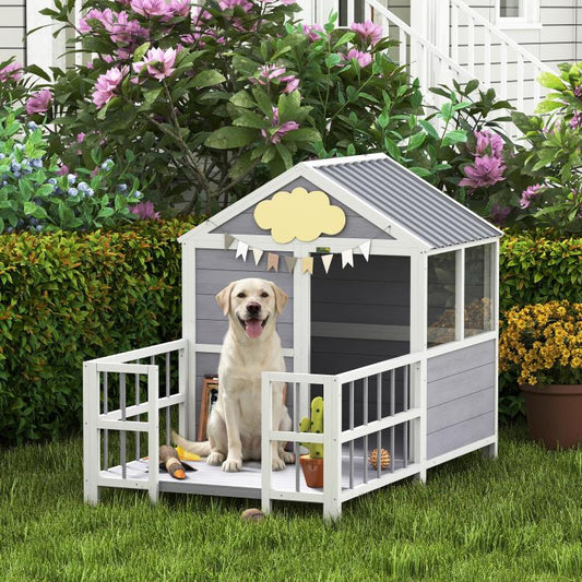 Outdoor wooden dog house with porch, gray siding, and a gray roof under flowers.