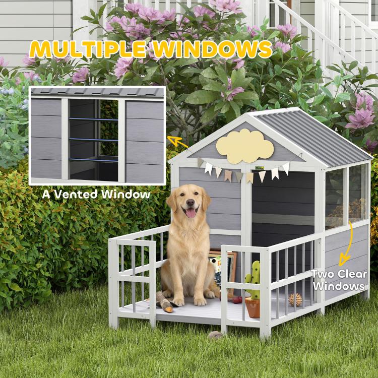 Outdoor dog house with vented windows, gray siding, and porch with white railings.