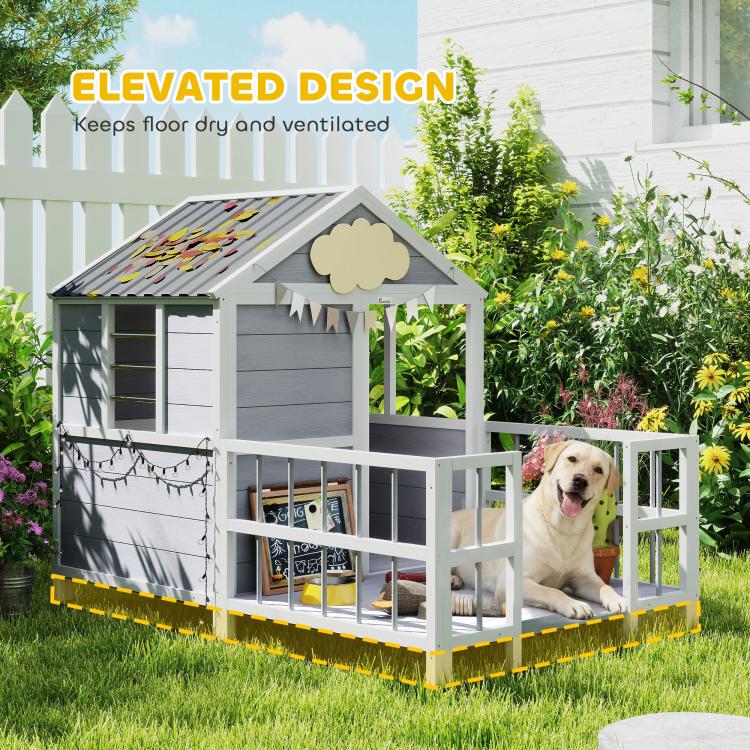 Elevated dog house with porch and dark roof, gray siding, and vented lower openings.