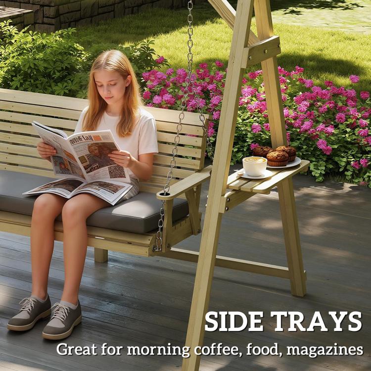 Natural wood 3-seat porch swing with gray cushion and hanging chains beside side trays