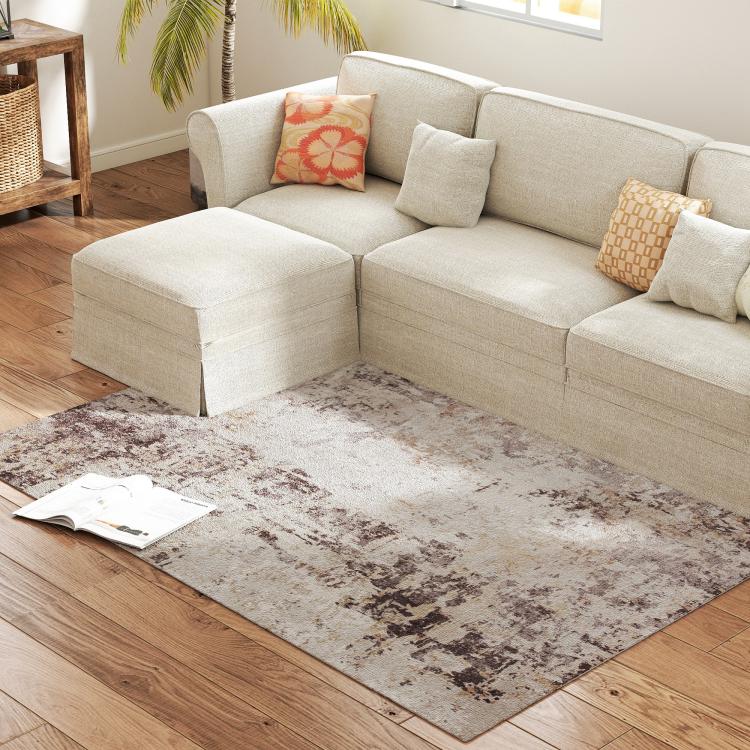 Abstract 4x6 area rug with faded brown and taupe distressed design on light ground