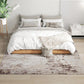 Abstract area rug under bed, light base with brown distressed texture pattern