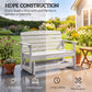 Distressed white slatted glider bench outdoors with armrests and rocking legs
