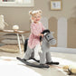 Gray plush rocking horse ride-on with bunny toy, toddler sitting and holding on