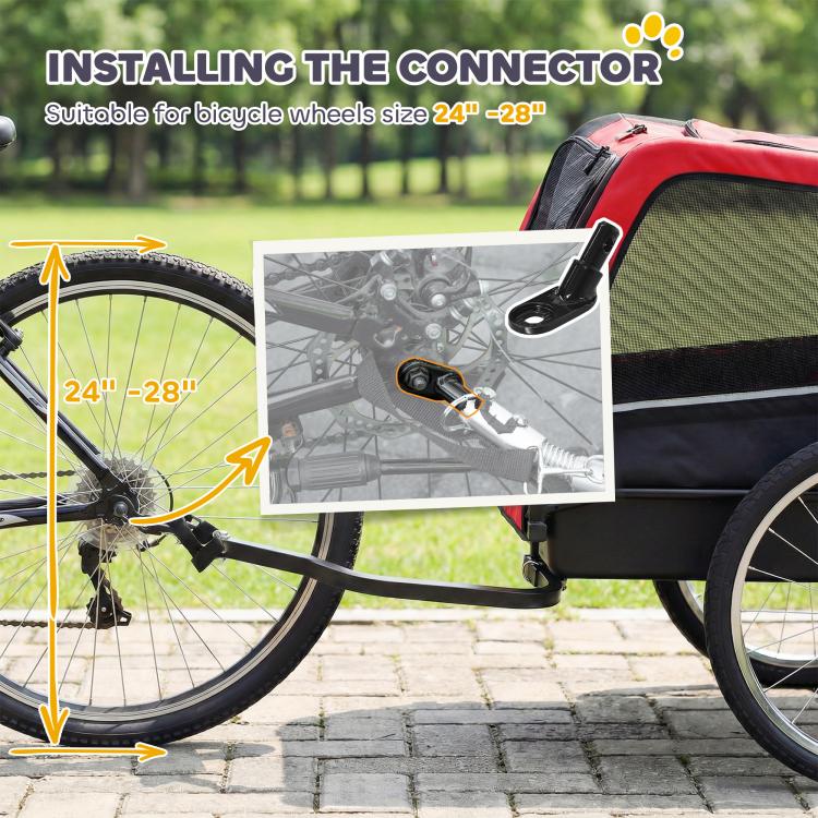 Red and black dog bike trailer with connector attachment near bicycle wheel and axle