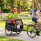 Dog bike trailer with red canopy, mesh sides, and a dog seated inside