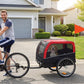 Red-and-black dog bike trailer with mesh door and four wheels, dog inside