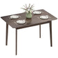 Rectangular dark brown dining table with angled legs and place settings