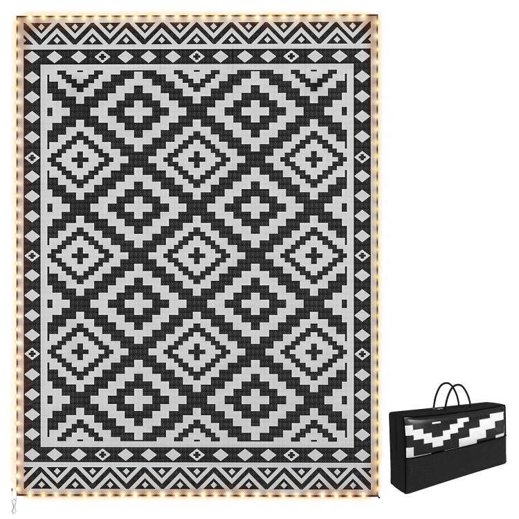 Outdoor reversible black-and-white geometric rug with LED lighted border