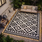 Outdoor reversible rug with black and white geometric pattern and edge LED lights