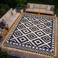 Outdoor geometric rug in black and white with illuminated LED edge border