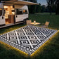 Outdoor black-and-white geometric rug with glowing LED border and patio seating