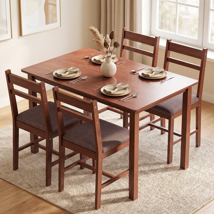 Light brown dining table with four upholstered chairs, clean farmhouse style