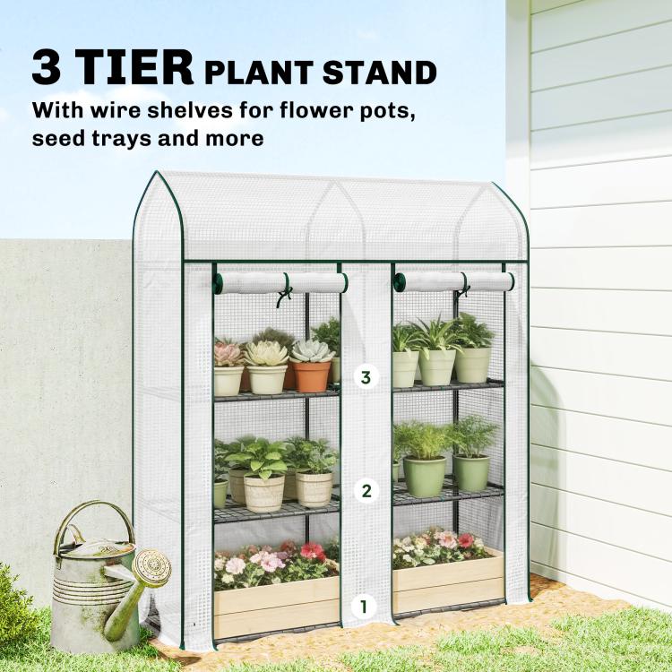 Small 3-tier mini greenhouse with wire shelves holding potted plants, white cover and green frame