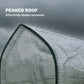 Peaked roof of a mini greenhouse with water droplets on white PE cover