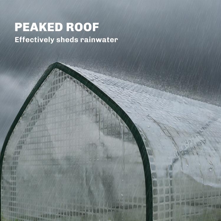Peaked roof of a mini greenhouse with water droplets on white PE cover