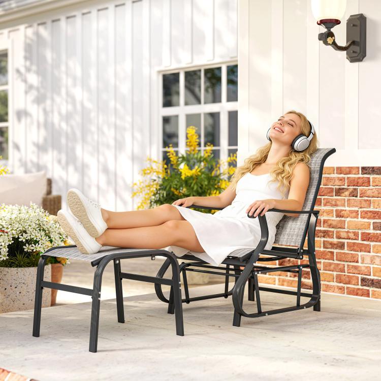 Gray patio glider chair with mesh seat and curved arms