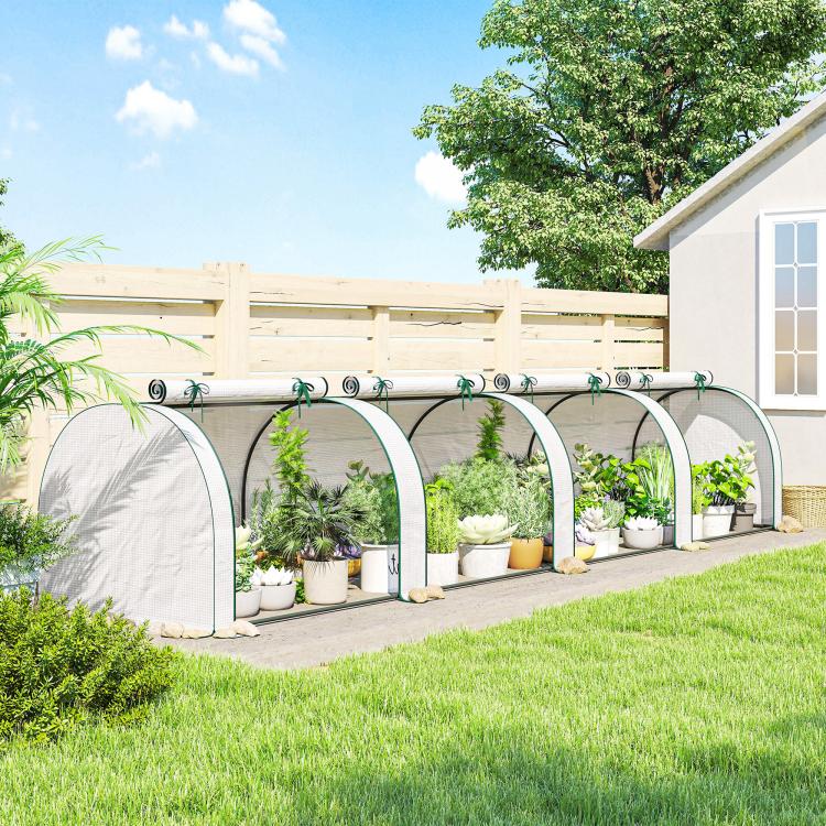 Portable garden greenhouse with arched white PE cover along a garden path